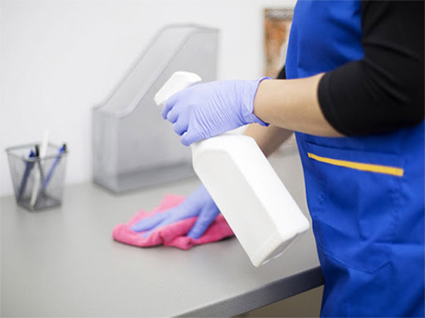 A kitchen countertop being cleaned.
