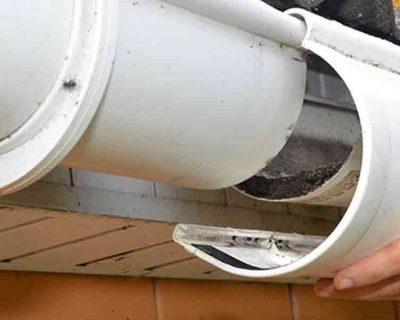A man repairing a broken gutter.