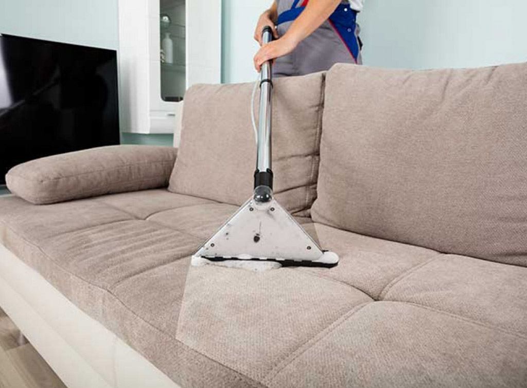 A sofa being professionally cleaned.